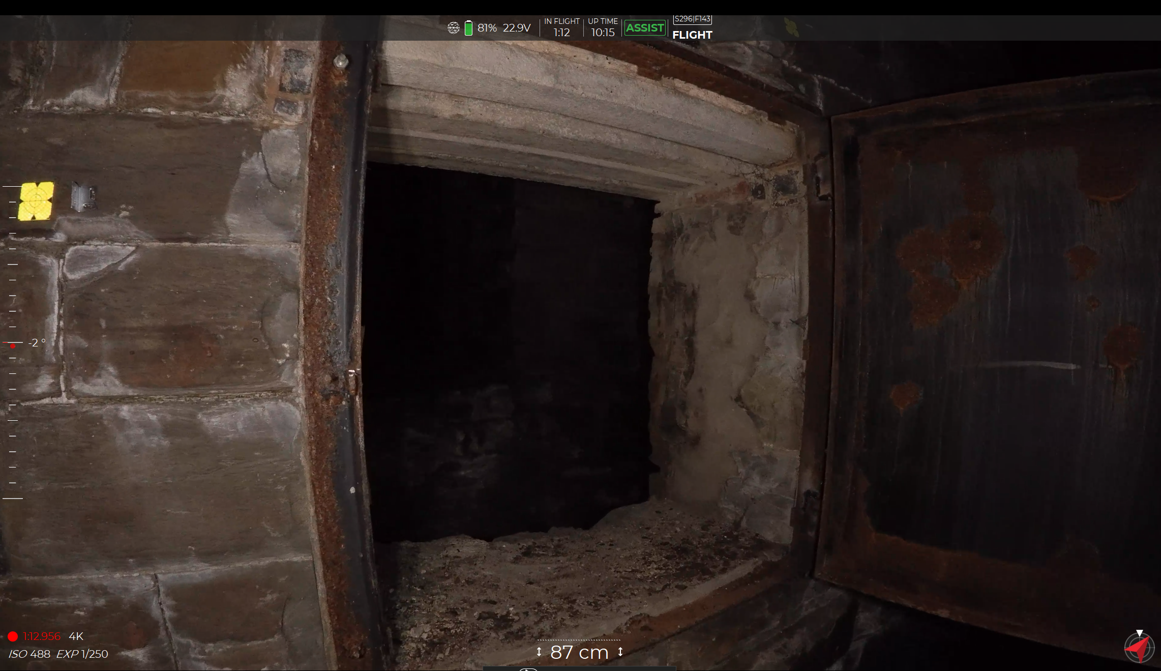 A photo of a hatch leading to a dark, unclear space behind. with no light